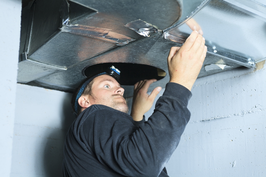 Technician checking ductwork
