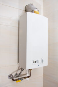 Home tankless gas water heater mounted on home's wall