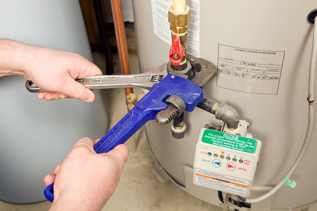 technician working on a water heater