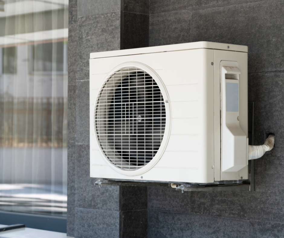 heat pump on the wall outside of a residental home